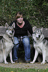 woman and american wolfdogs