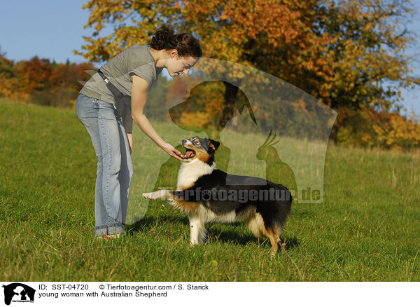 young woman with Australian Shepherd / SST-04720