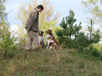 man with Australian Shepherds