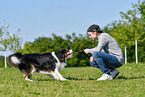 man with Australian Shepherd