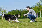 man with Australian Shepherd