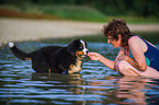 woman and young Bernese Mountain Dog