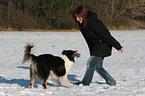 playing with dog in the snow
