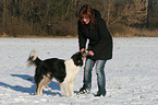 playing with dog in the snow
