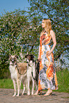woman and 2 Borzois