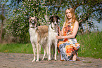 woman and 2 Borzois