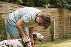 woman brushes dog