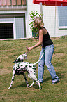 woman plays with dog