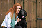 woman with Flat Coated Retriever