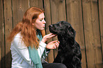woman with Flat Coated Retriever