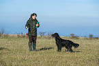 woman and Flat Coated Retriever