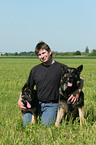 man and German Shepherds