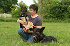 man and German Shepherds