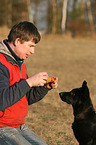 man and young German Shepherd