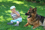 child and German Shepherd