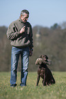man and German shorthaired Pointer