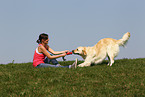 woman plays with Golden Retriever