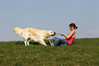 woman plays with Golden Retriever