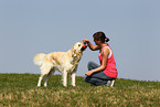 woman plays with Golden Retriever