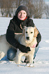 woman and Golden Retriever in snow