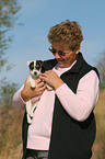 woman fondles Jack Russell Terrier Puppy