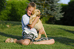 boy with labrador retriever puppy