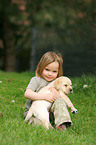 girl with Labrador Retriever puppy