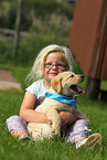 girl with Labrador Retriever Puppy