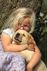 girl with Labrador Retriever Puppy