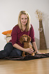 woman and young Magyar Vizsla