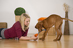 woman and young Magyar Vizsla