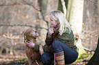 woman and shorthaired Magyar Vizsla