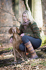 woman and shorthaired Magyar Vizsla