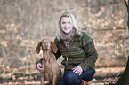 woman and shorthaired Magyar Vizsla