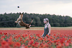 woman with  Malinois in the poppy field