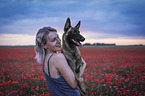 woman with Malinois in the poppy field
