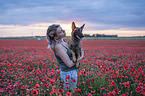 woman with Malinois in the poppy field