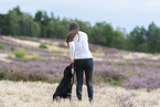 young woman with Miniature Australian Shepherd