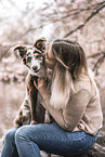 woman and Miniature Australian Shepherd