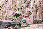 woman and Miniature Australian Shepherd