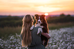 young woman with Miniature Australian Shepherd