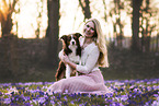 young woman with Miniature Australian Shepherd