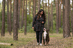 woman and Miniature Australian Shepherd
