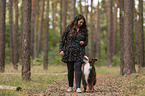 woman and Miniature Australian Shepherd