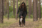 woman and Miniature Australian Shepherd