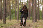 woman and Miniature Australian Shepherd