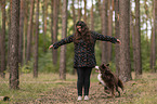 woman and Miniature Australian Shepherd