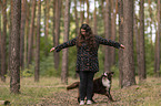 woman and Miniature Australian Shepherd