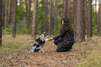woman and Miniature Australian Shepherd