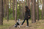 woman and Miniature Australian Shepherd